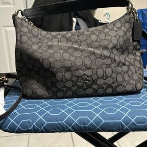 Zippered black fabric coach purse with leather straps